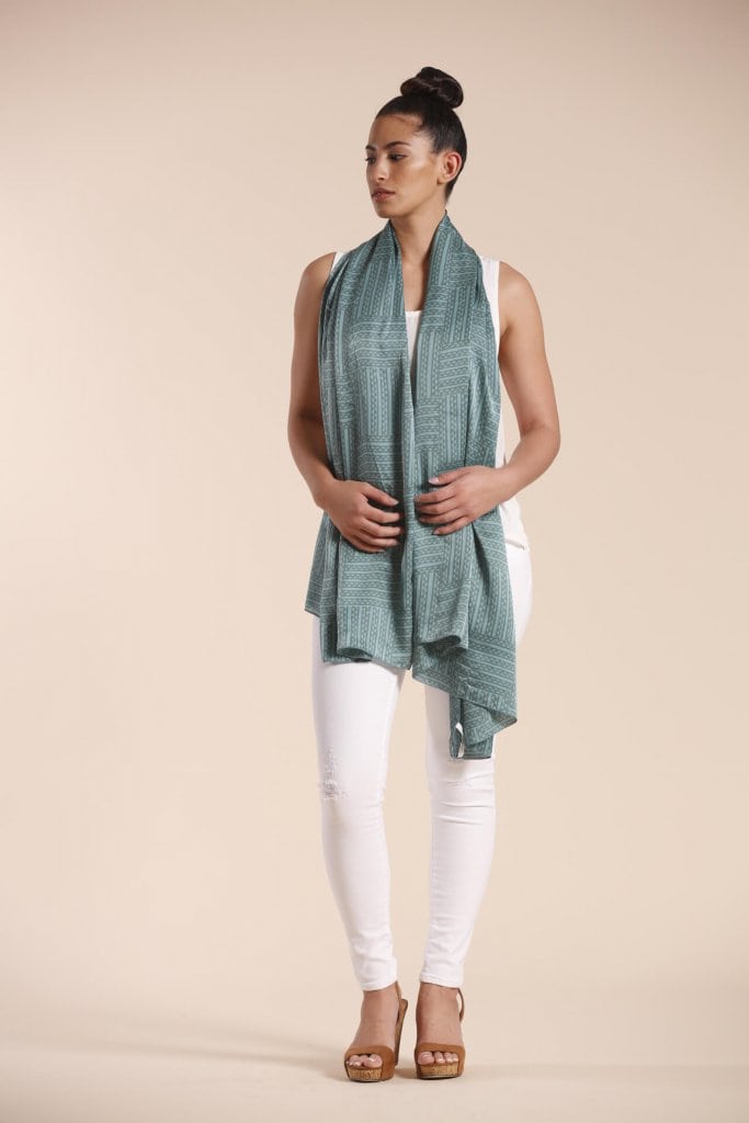 Female model wearing a sage green scarf