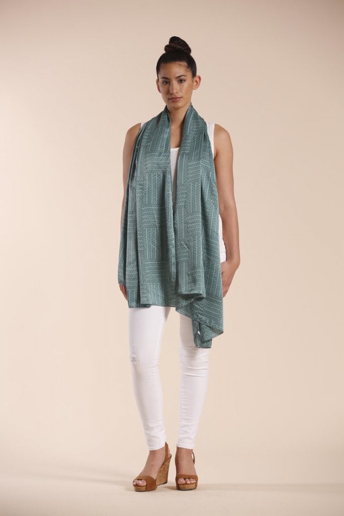 Female model wearing a sage green scarf