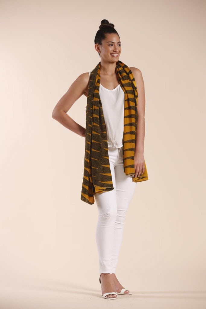 Female model wearing a mustard scarf