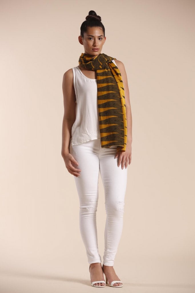 Female model wearing a mustard scarf