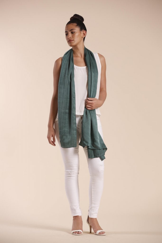 Female model wearing a sage green scarf