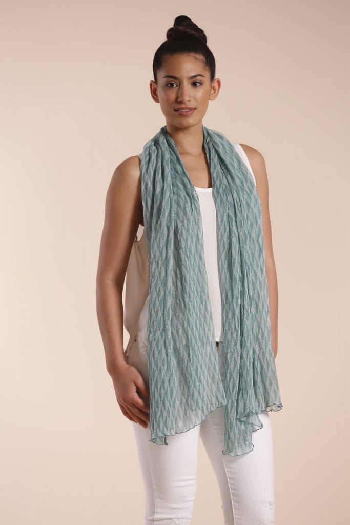 Female model wearing a sage green scarf