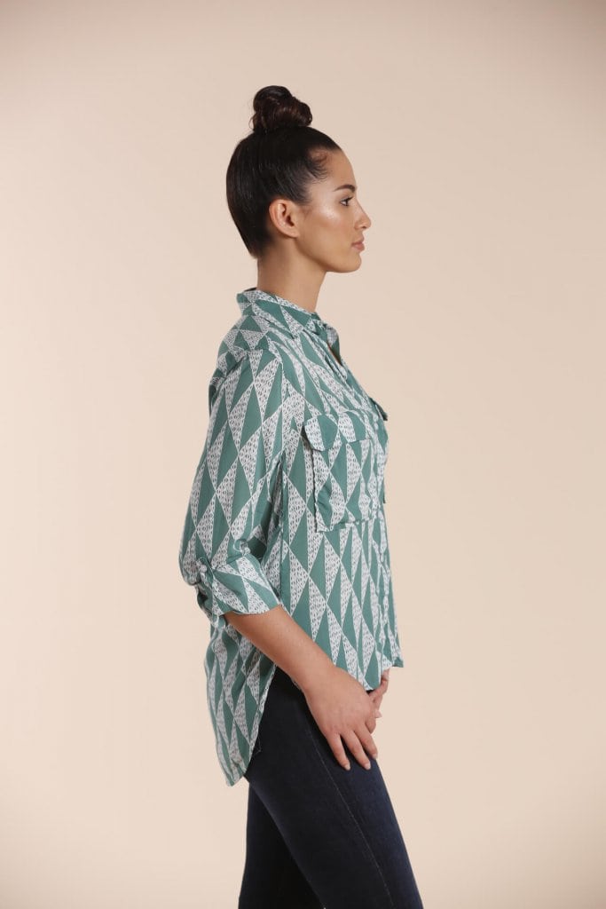 Female model wearing a Long Sleeve Button Shirt in sage green - Side View