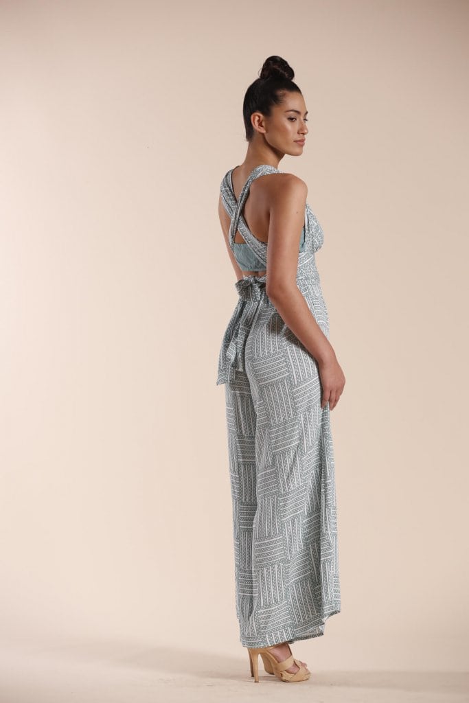 Female model wearing a Jumpsuit in light green - Back View