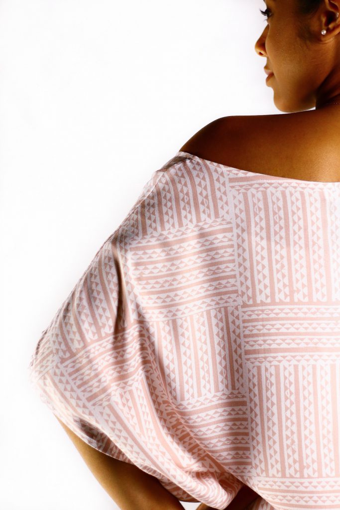 Female model wearing a Manaola Dress in Light Pink - Back View