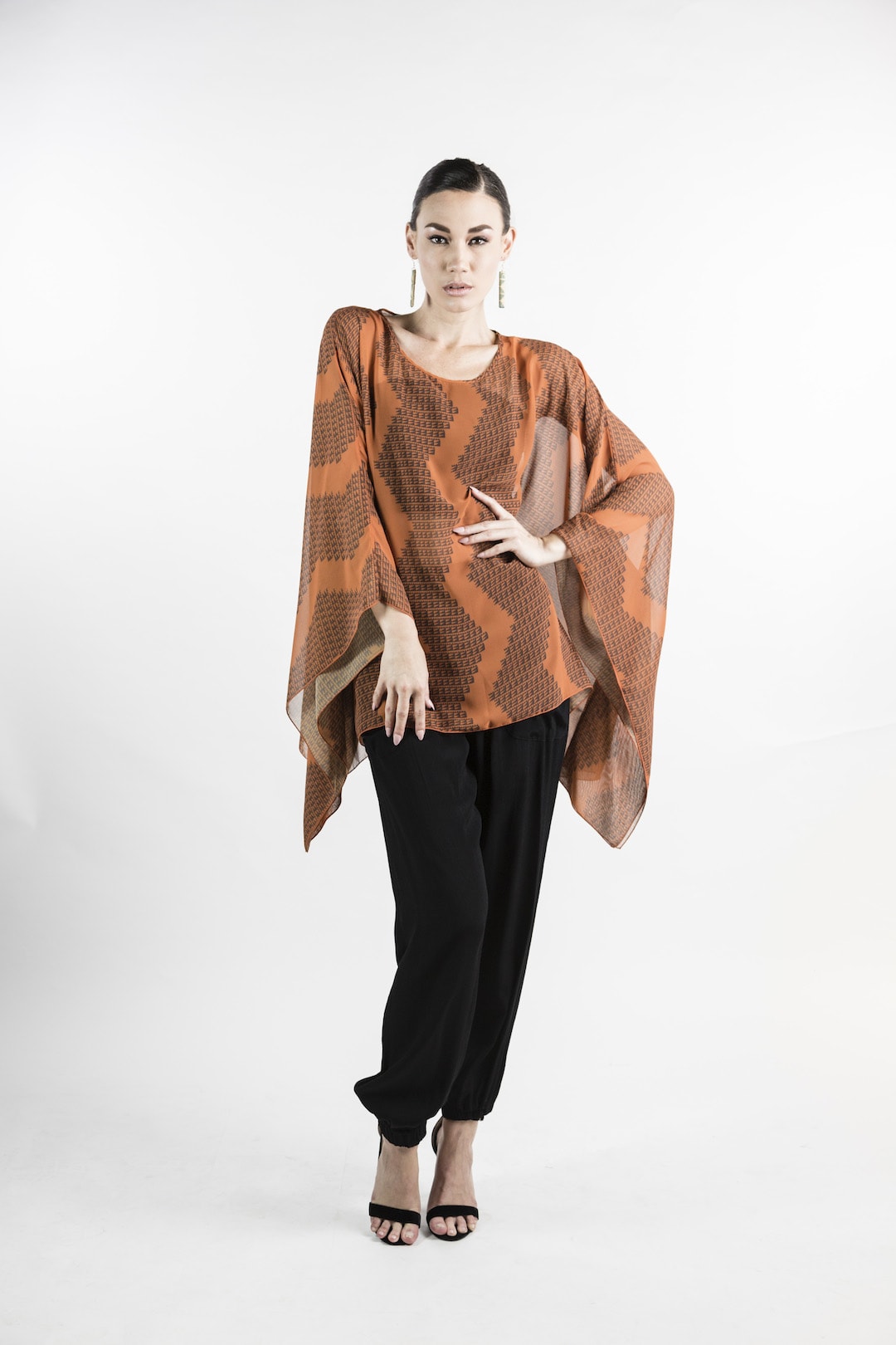 Female model wearing Kaftan in Rust - Front View