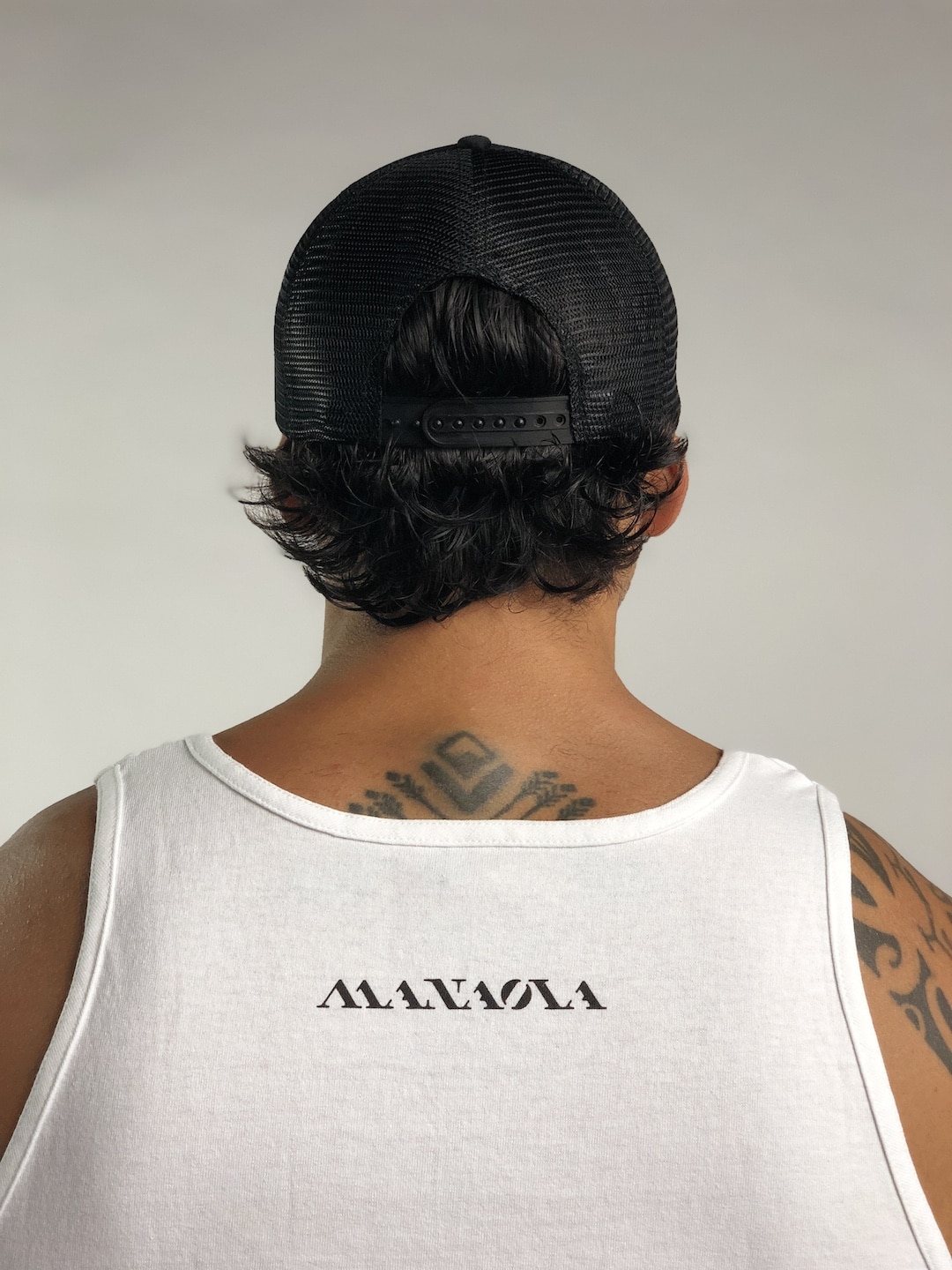 Male model wearing Logo Trucker Hat in Black - Back View