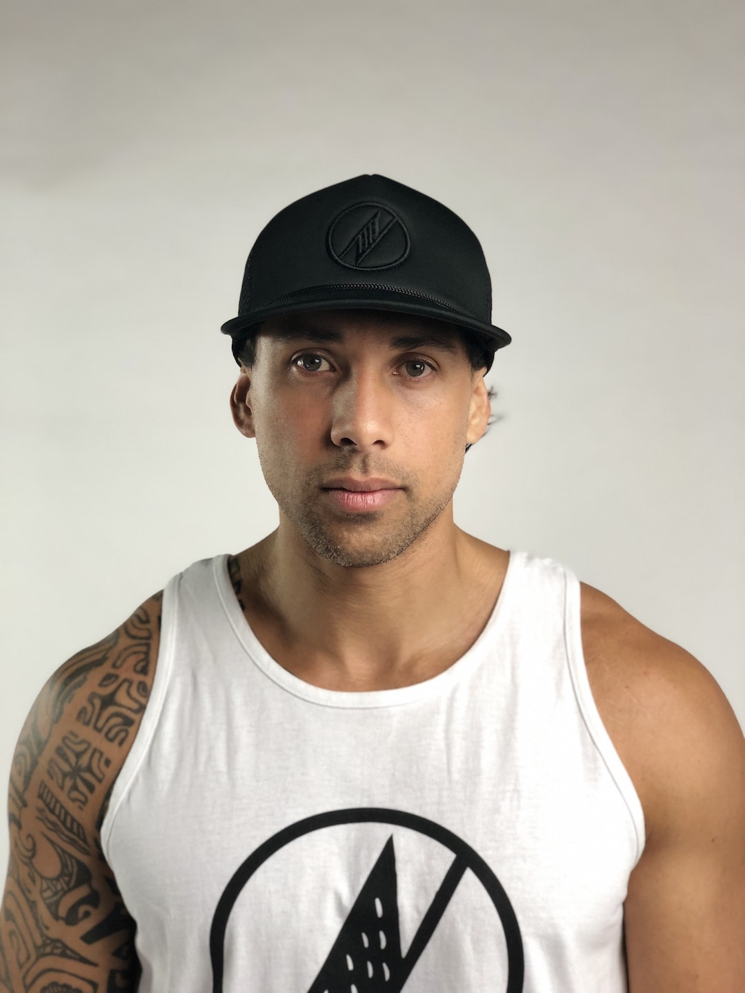 Male model wearing Logo Trucker Hat in Black - Front View