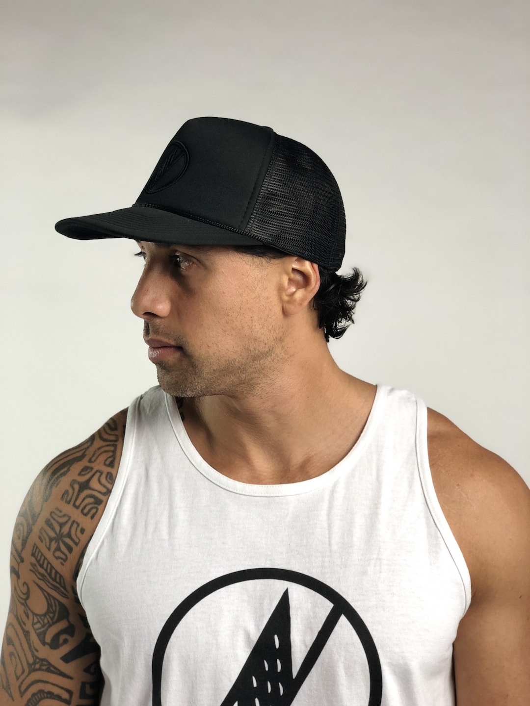 Male model wearing Logo Trucker Hat in Black - Side View