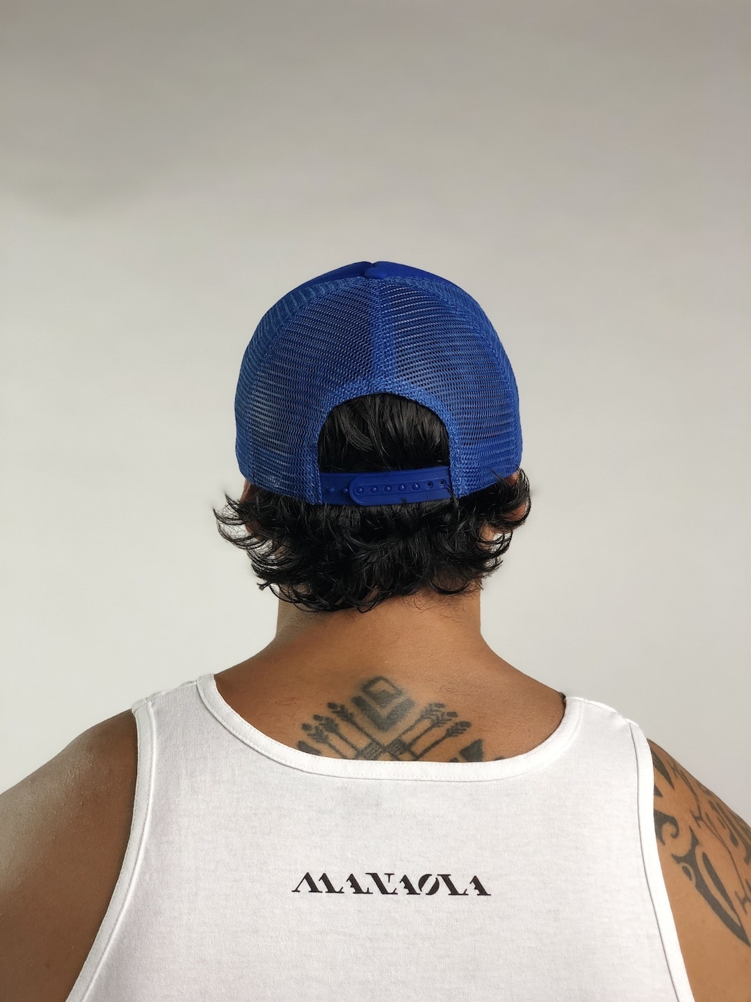 Male model wearing Logo Trucker Hat in Blue - Back View