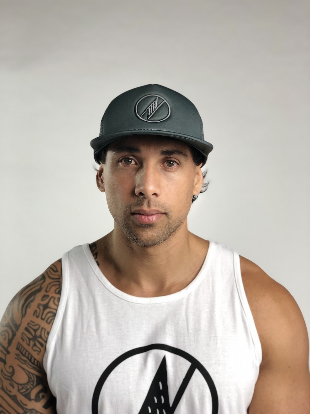 Male model wearing Logo Trucker Hat in Grey - Front View