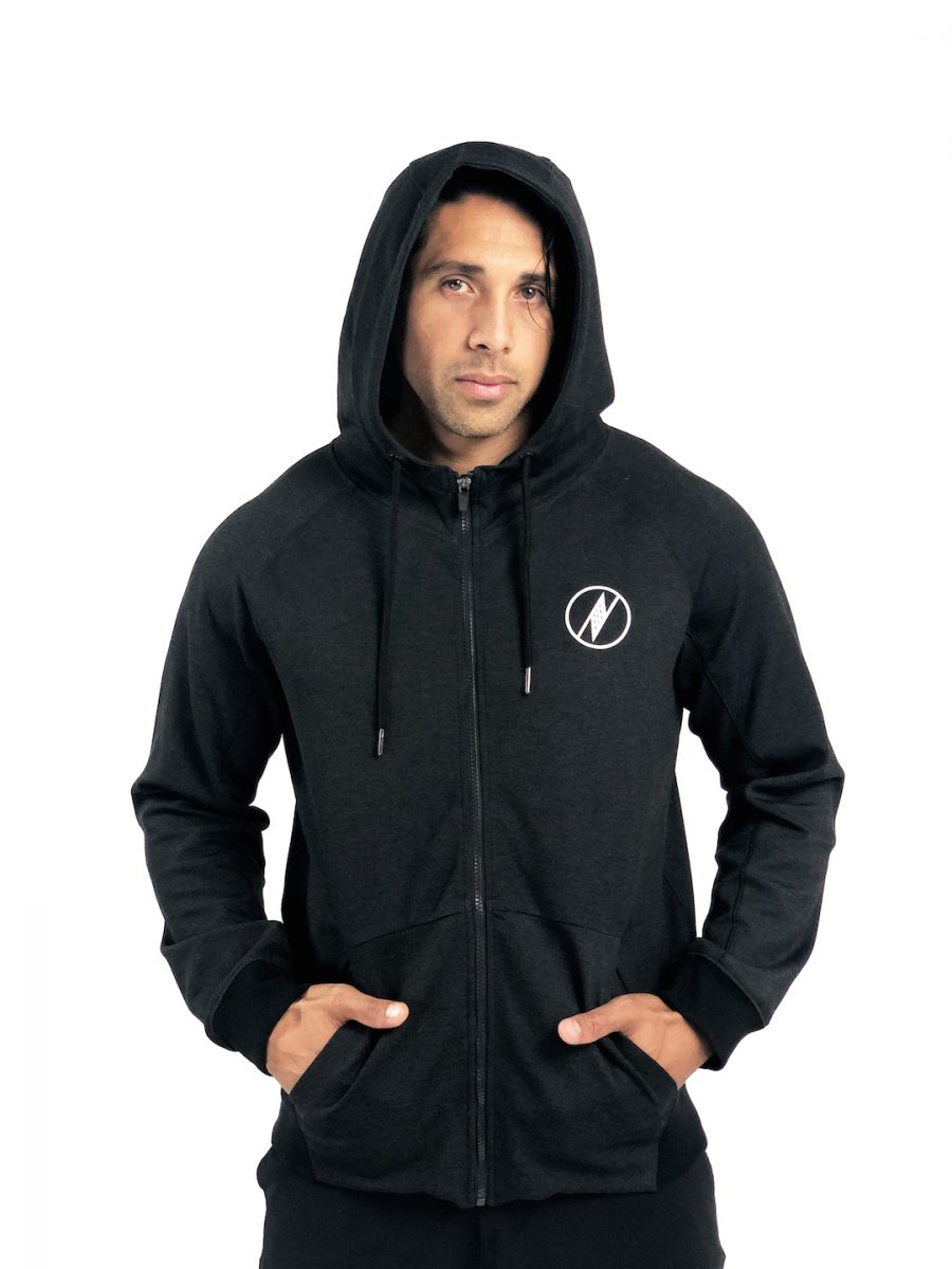 Male model wearing a Uwila Logo Jacket in Black - Front View