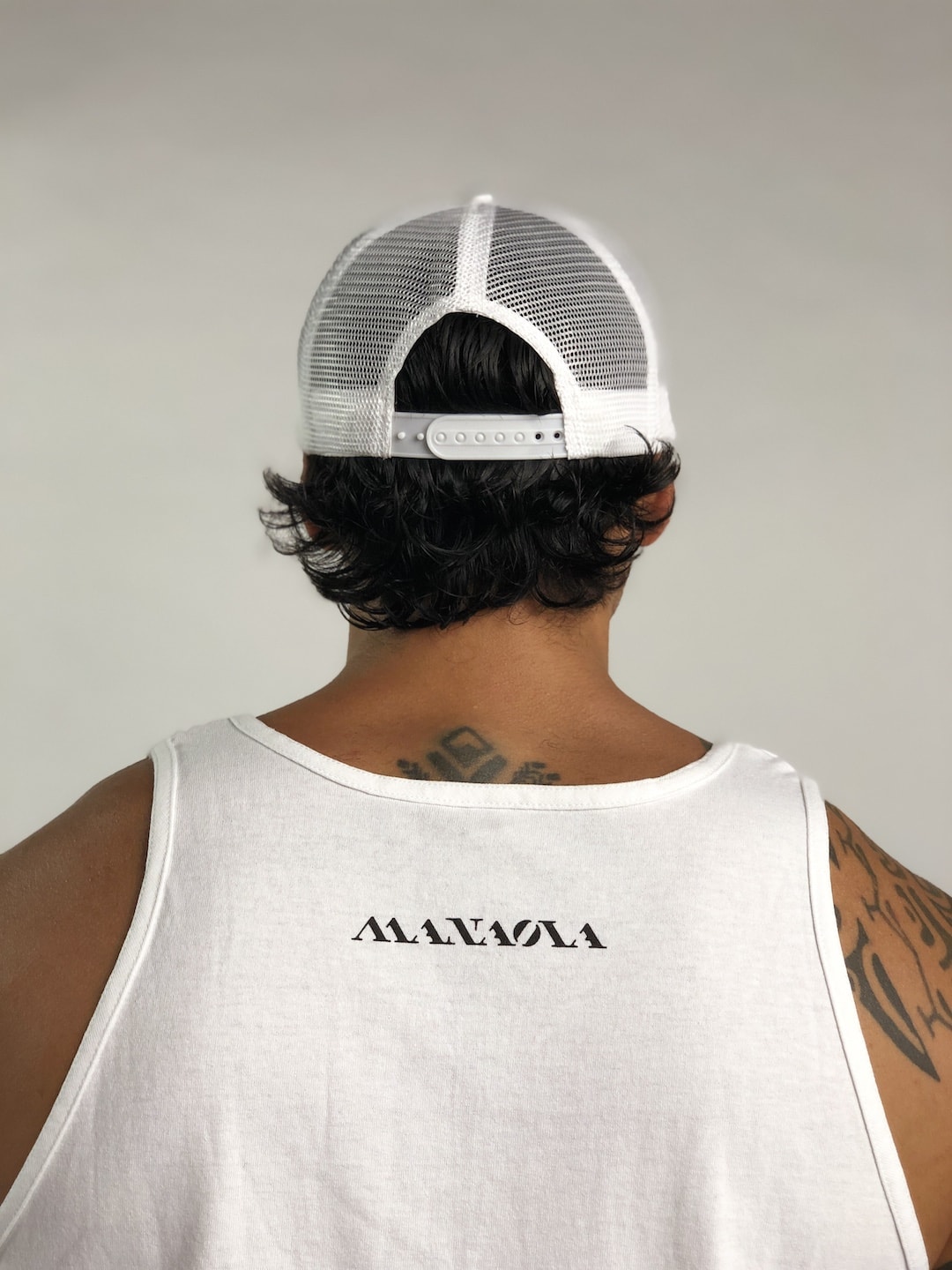 Male model wearing Logo Trucker Hat in White - Back View