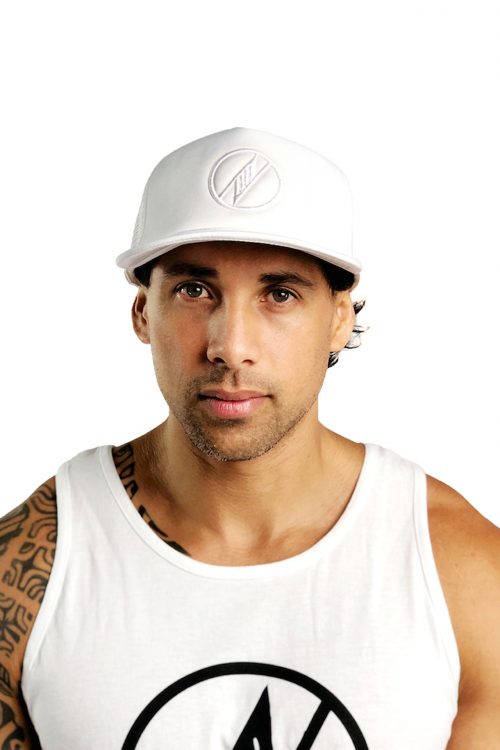 Male model wearing Logo Trucker Hat in White - Front View