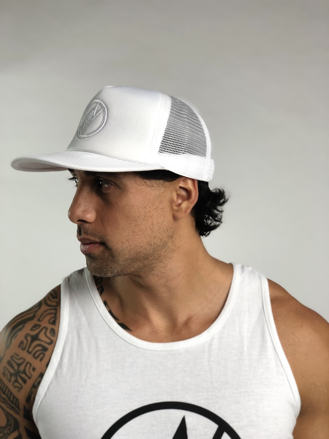Male model wearing Logo Trucker Hat in White - Side View