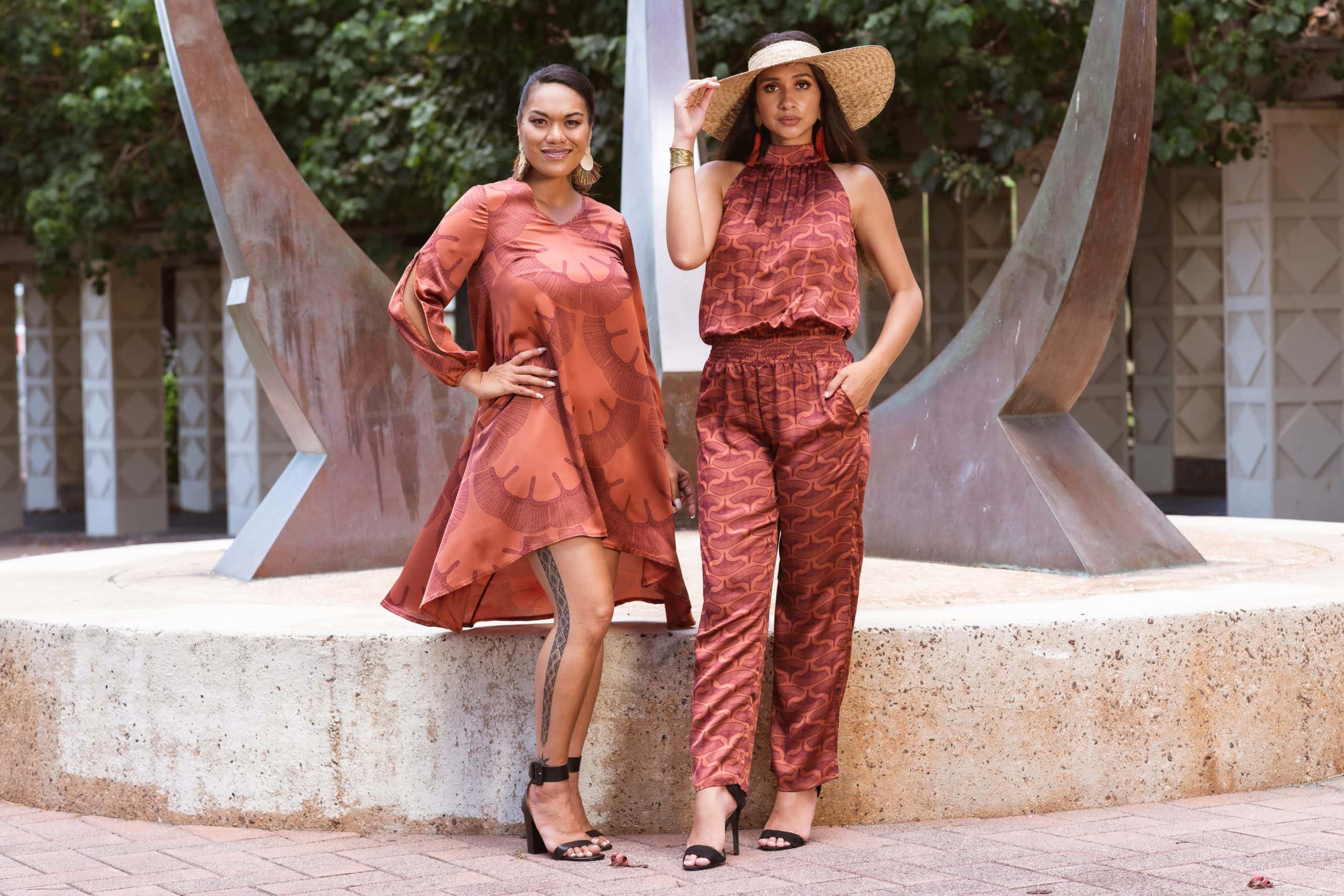 Models wearing Keaolani and Noveo Jumpsuit in Copper/Red Mahagony - Front View