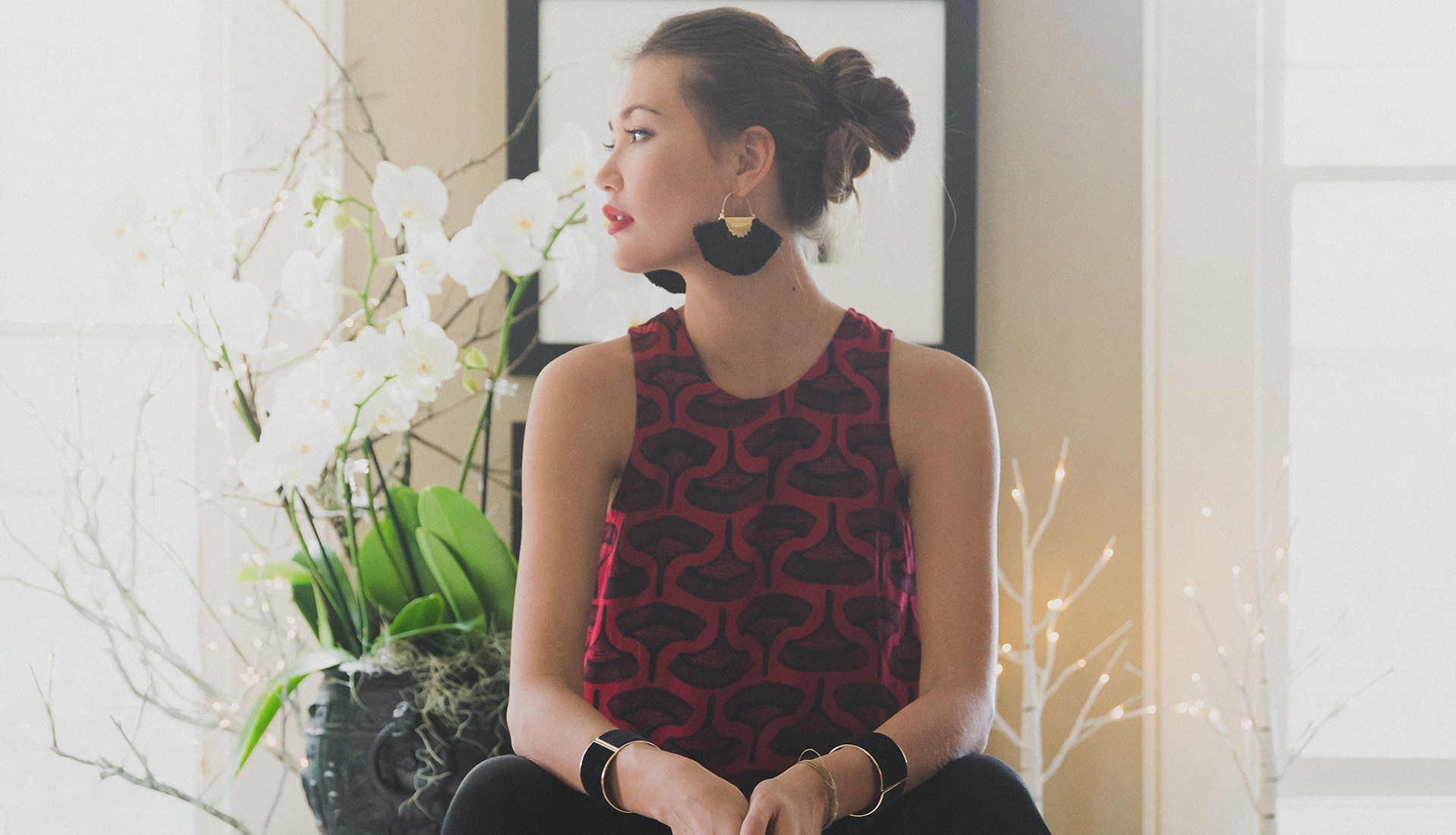 Model wearing Manaola Shirt in Red looking to her left