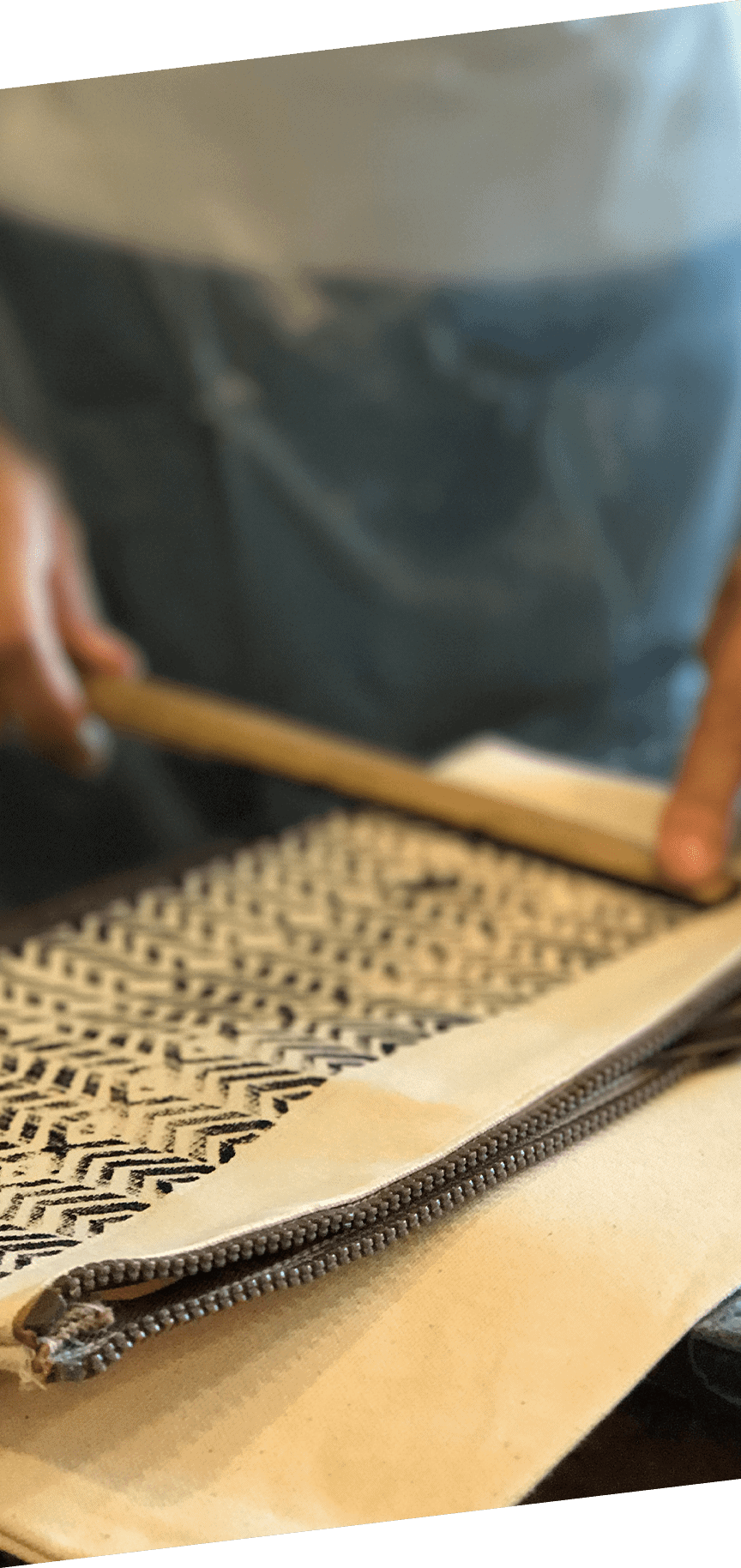 Person pressing a pattern onto a bag