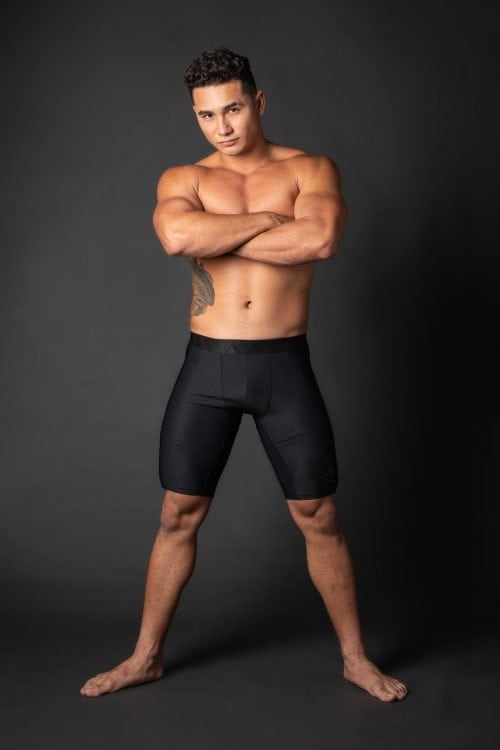 Male model wearing Uwila Midway Briefs in Black Solid Pattern - Front View