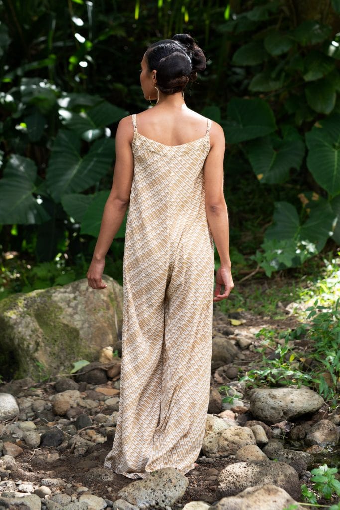 Model wearing Halaula jumpsuit in Tannin/Moonbeam - Back View