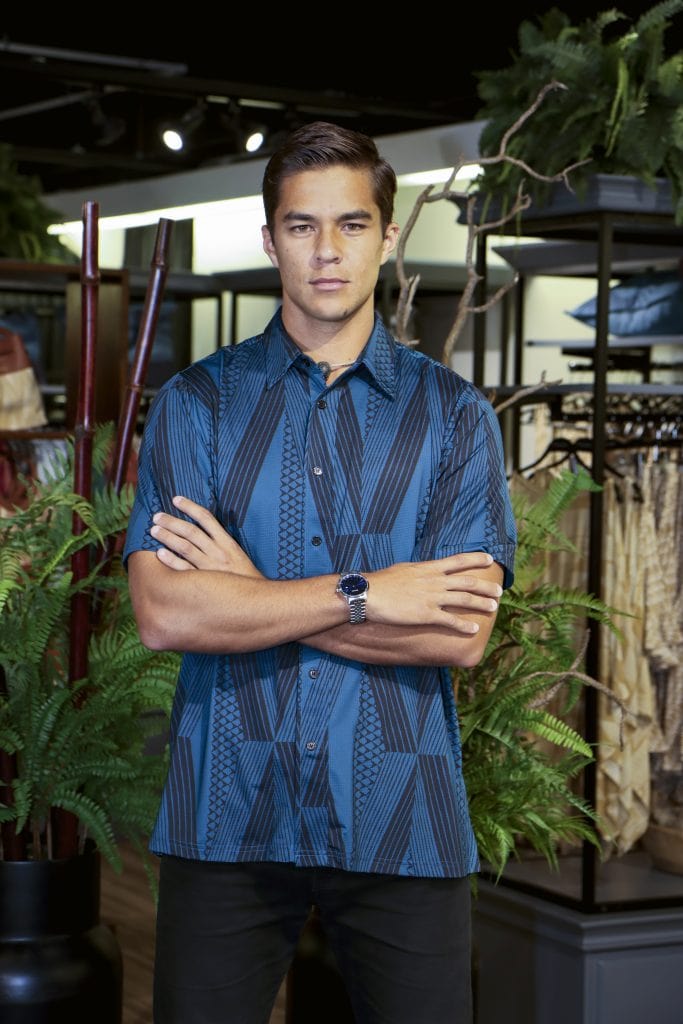 Male model wearing Golf Aloha Button in Blue Sapphire Black Kanaloa Pattern - Front View