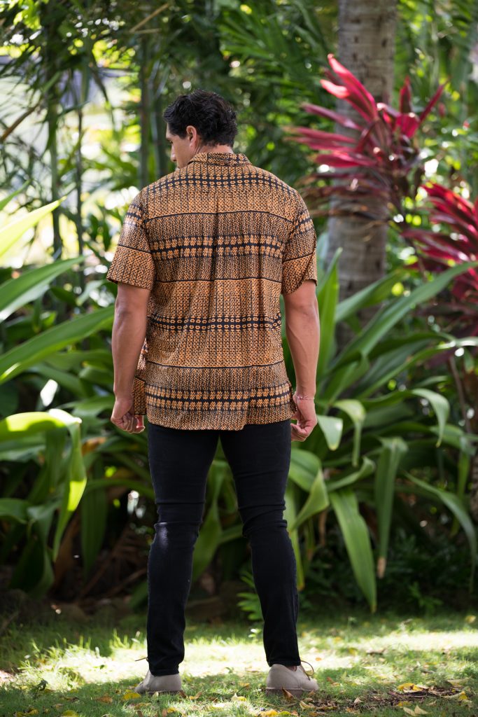 Male model wearing Golf Aloha Button Shirt in Golden Yellow Black Akoakoa Pattern - Back View