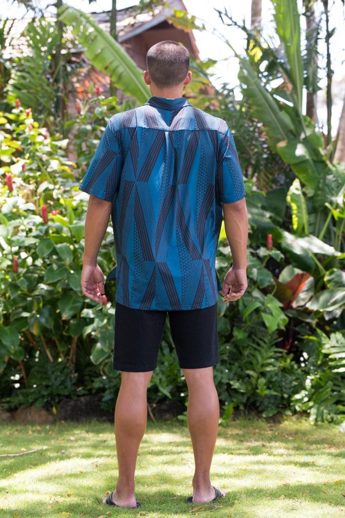 Male model wearing Golf Aloha Pullover in Blue Sapphire Back Kanaloa Pattern - Black View