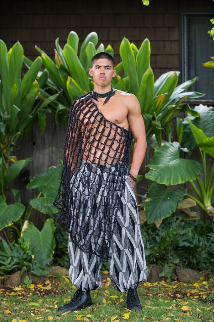 Male model wearing Mahiki Pant in Black Windchime Kanaloa Pattern - Front View