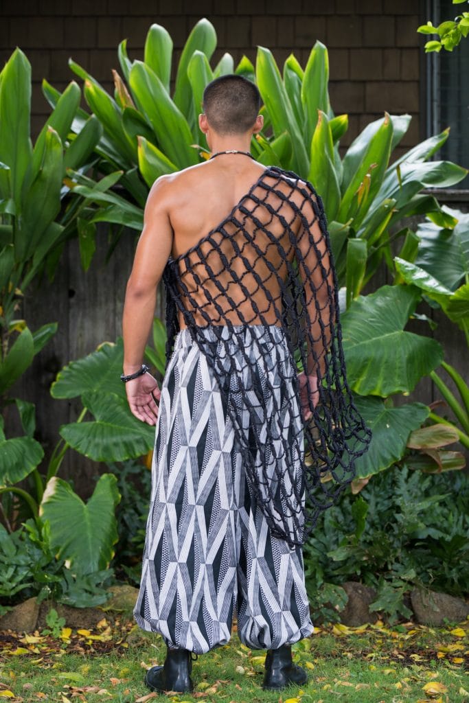 Male model wearing Mahiki Pant in Black Windchime Kanaloa Pattern - Back View