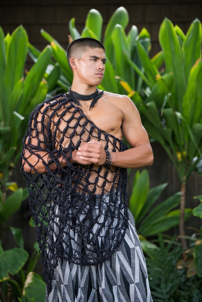 Male model wearing Mahiki Pant in Black Windchime Kanaloa Pattern - Front View