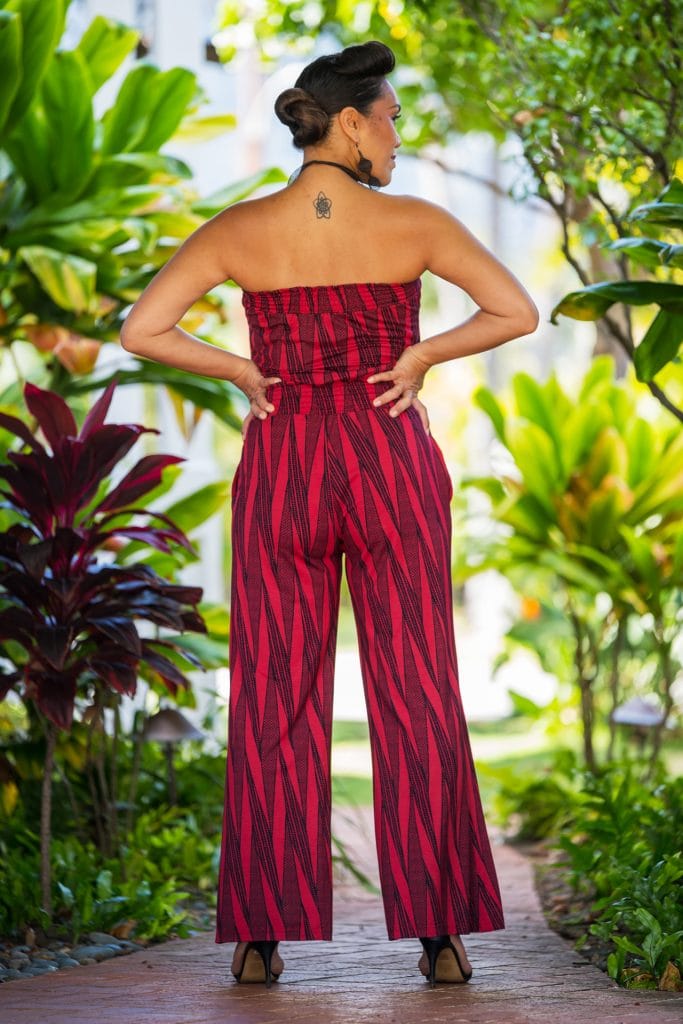Model wearing Pakalana Jumpsuit in Brick Red Deepwell Kialoa Pattern - Back View