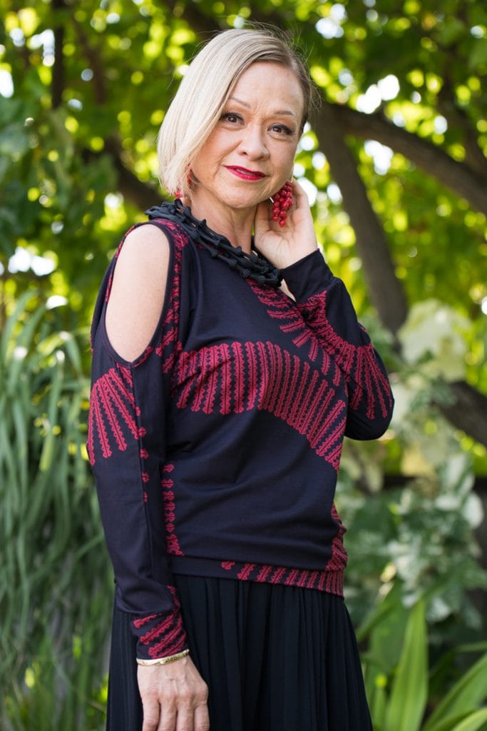 Model wearing Kipoohiwi Top in Deepwell Brick Red Lalani Kalalea Pattern - Front View