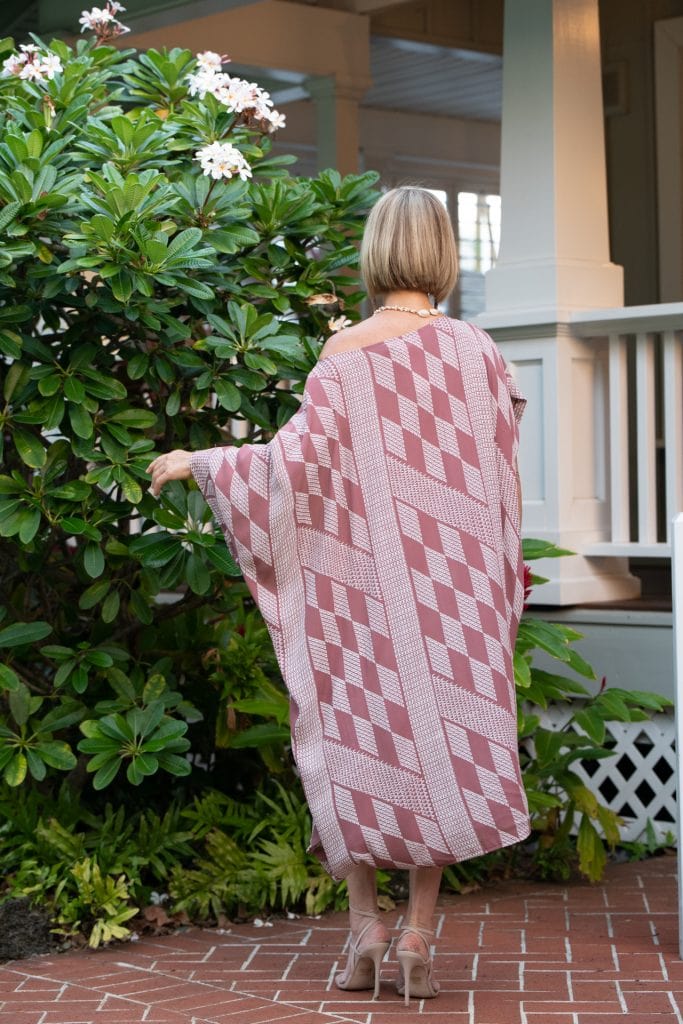 Model wearing Hilu Hilu Kaftan in Fired Brick White Kamehahema Pattern - Back View