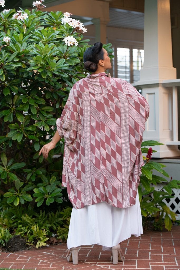 Female model wearing Top Aali'i in Fired Brick White Kamehameha Pattern - Back View