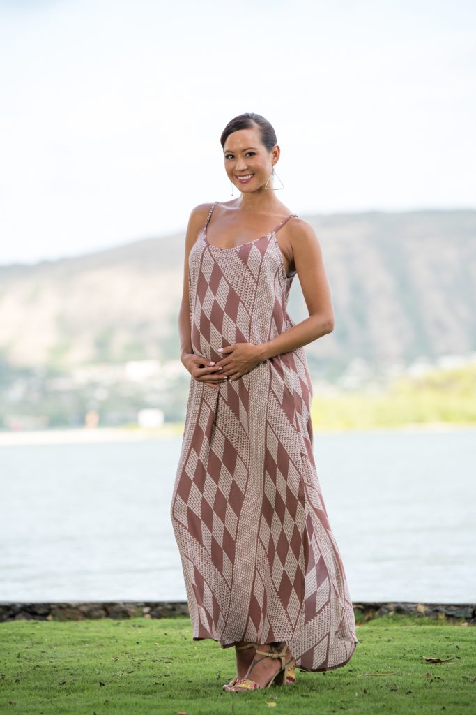 Model wearing Uluniu Maxi Dress in Fired Brick White Kamehameha Pattern - Front View