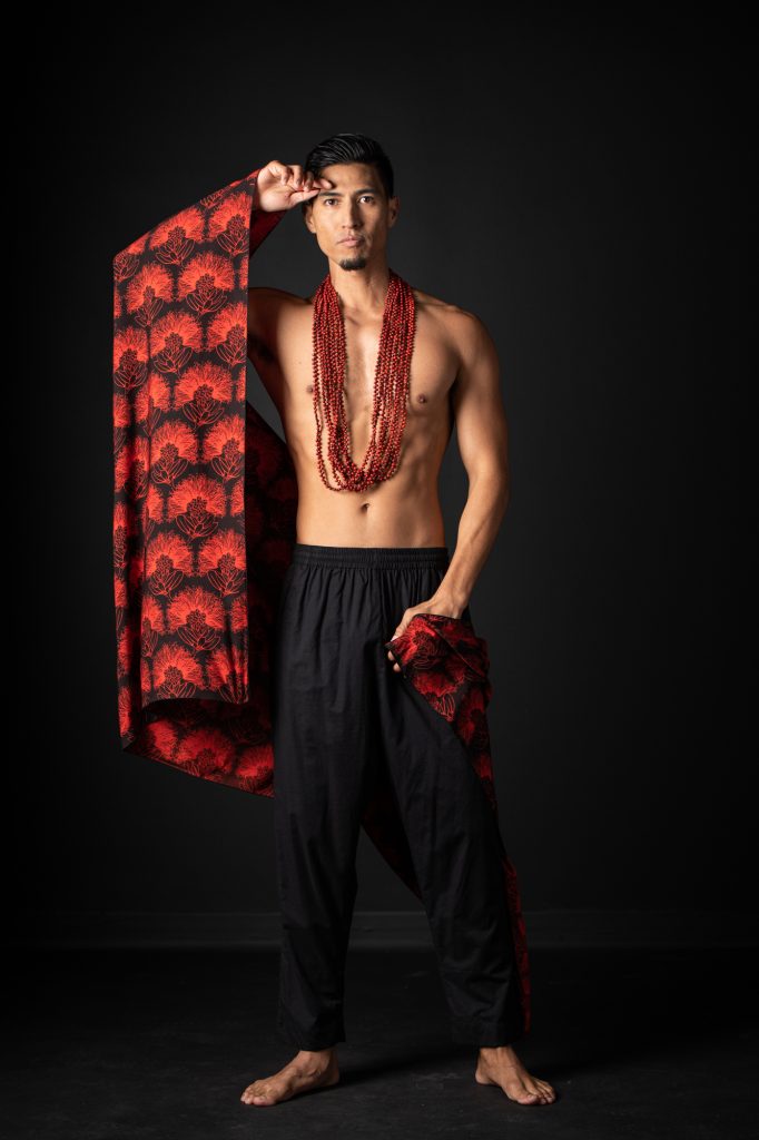 Model wearing Pareo shawl in Firey Red Black Kalihilehua Pattern