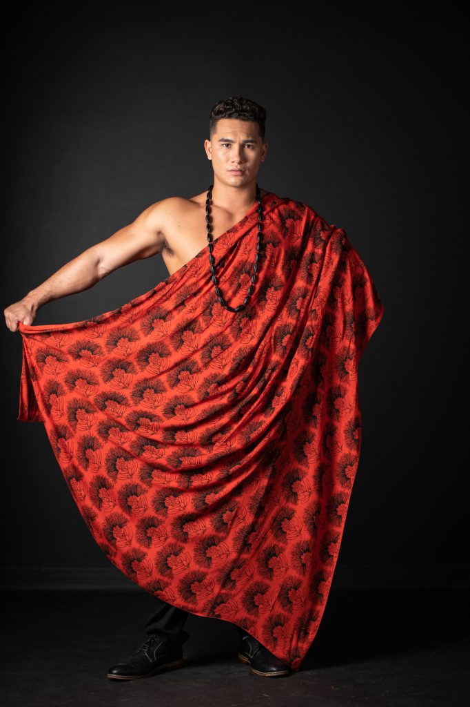 Model wearing Pareo shawl in Firey Red Black Kalihilehua Pattern