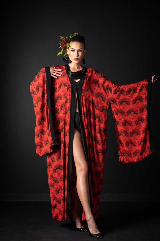 Model wearing Kaliko Kaftan in Firey Red Black Kalihilehua Pattern