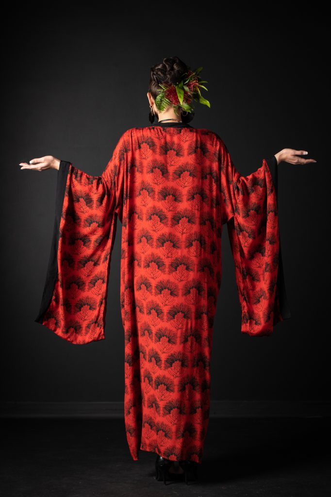 Model wearing Kaliko Kaftan in Firey Red Black Kalihilehua Pattern - Back View