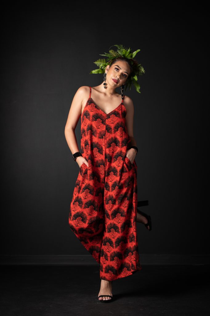 Model wearing LANIHAU JUMPSUIT in Firey Red Black Kalihilehua Pattern - Front View