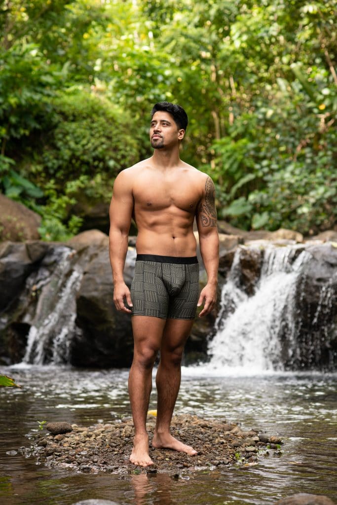 Male model wearing Manaola Boxer Trunk in Martini Olive-Jet Black Ulana Pattern - Front View