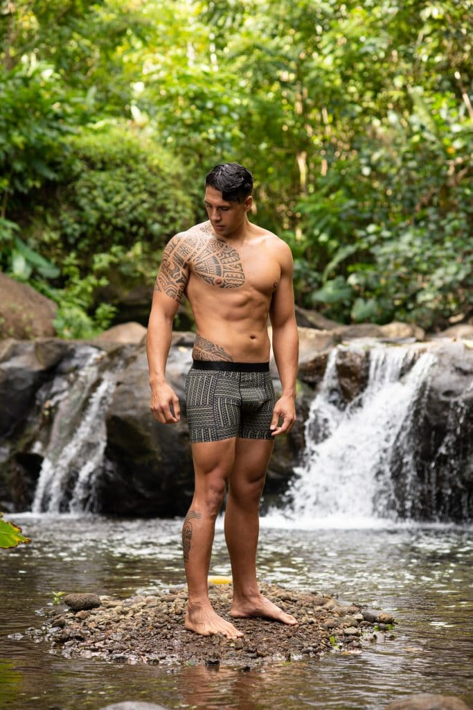 Male model wearing Manaola Boxer Trunk in Martini Olive-Jet Black Ulana Pattern - Front View