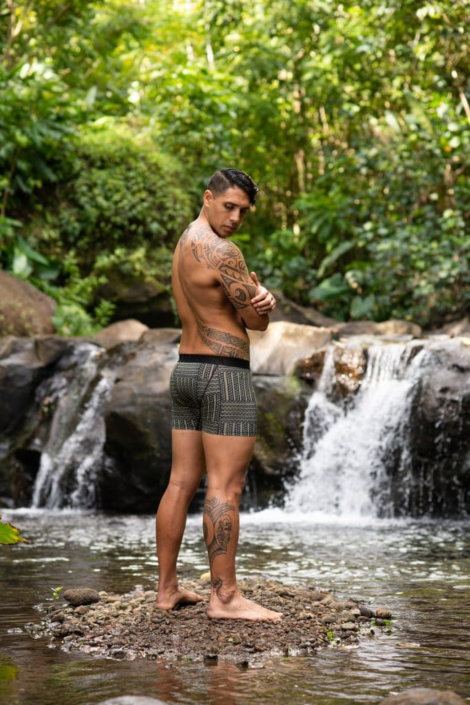 Male model wearing Manaola Boxer Trunk in Martini Olive-Jet Black Ulana Pattern - Back View