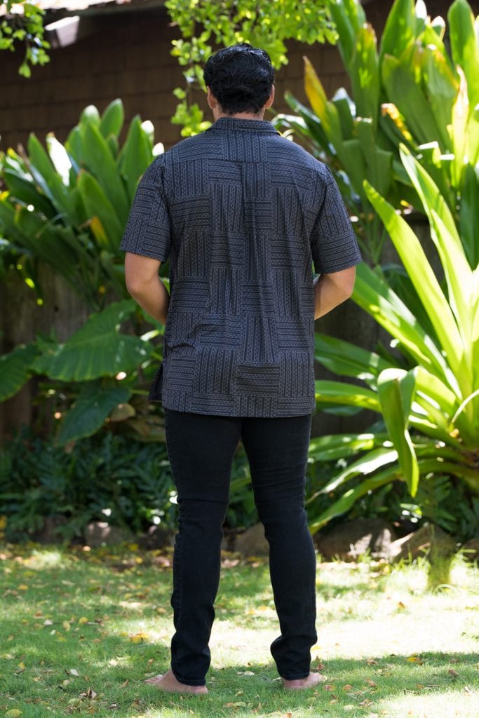 Male model wearing Golf Aloha Button Shirt in Blackened Pearl Black Ulana Pattern - Back View