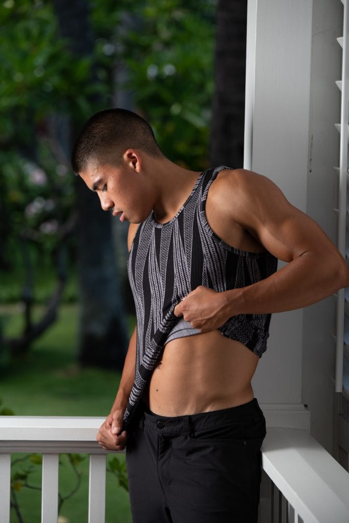 Male model wearing Kawelo Ribbed Tank in Jet Black Silver Filigree Kialoa Pattern - Side View