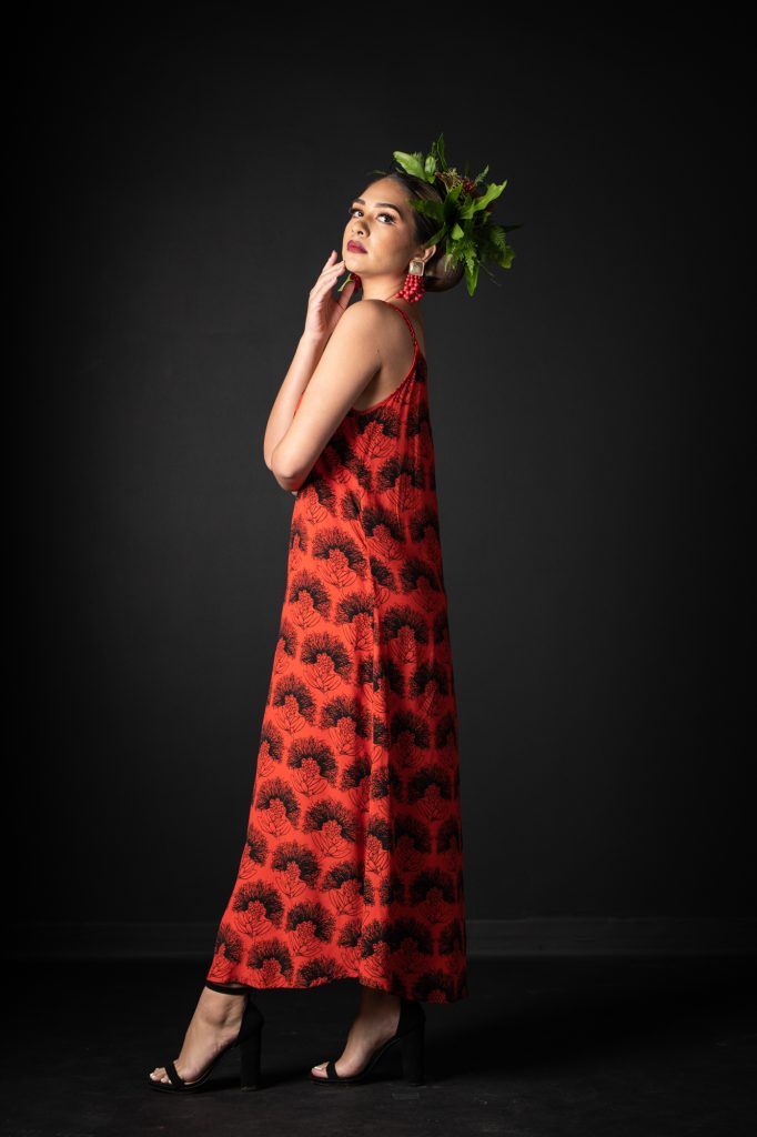 Model wearing Uluniu Maxi Dress in Firey Red-Black Kalihilehua Pattern - Side View