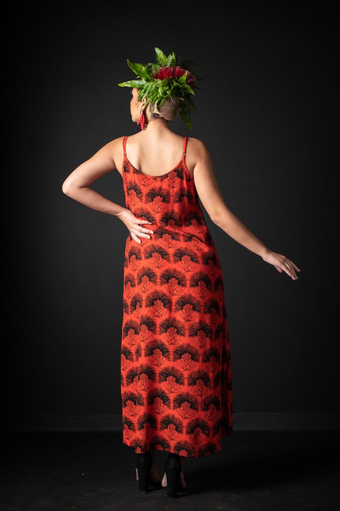 Model wearing Uluniu Maxi Dress in Firey Red-Black Kalihilehua Pattern - Back View