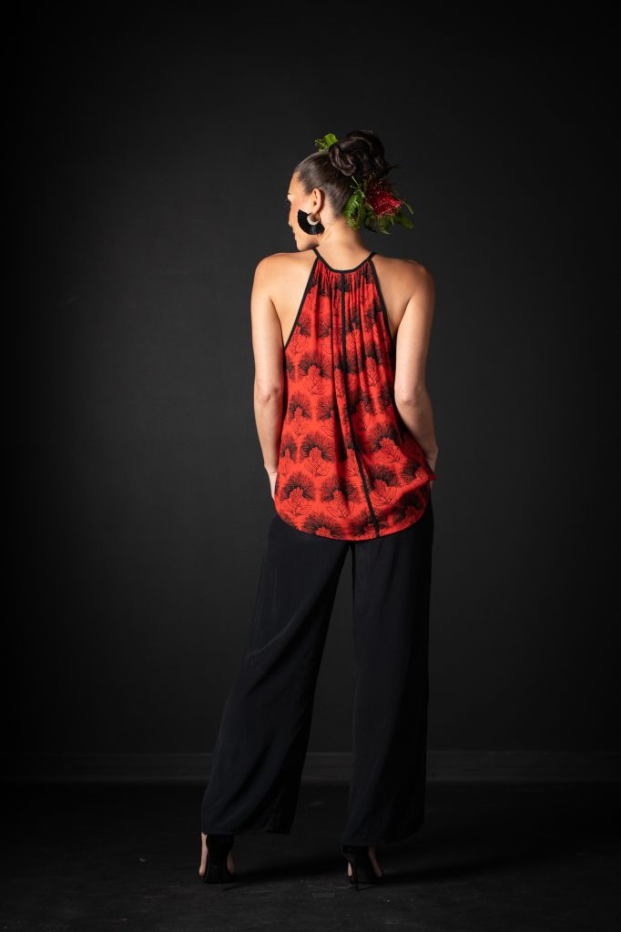 Model wearing Kaiulani Top in Firey Red Black Kalihilehua Pattern - Back View