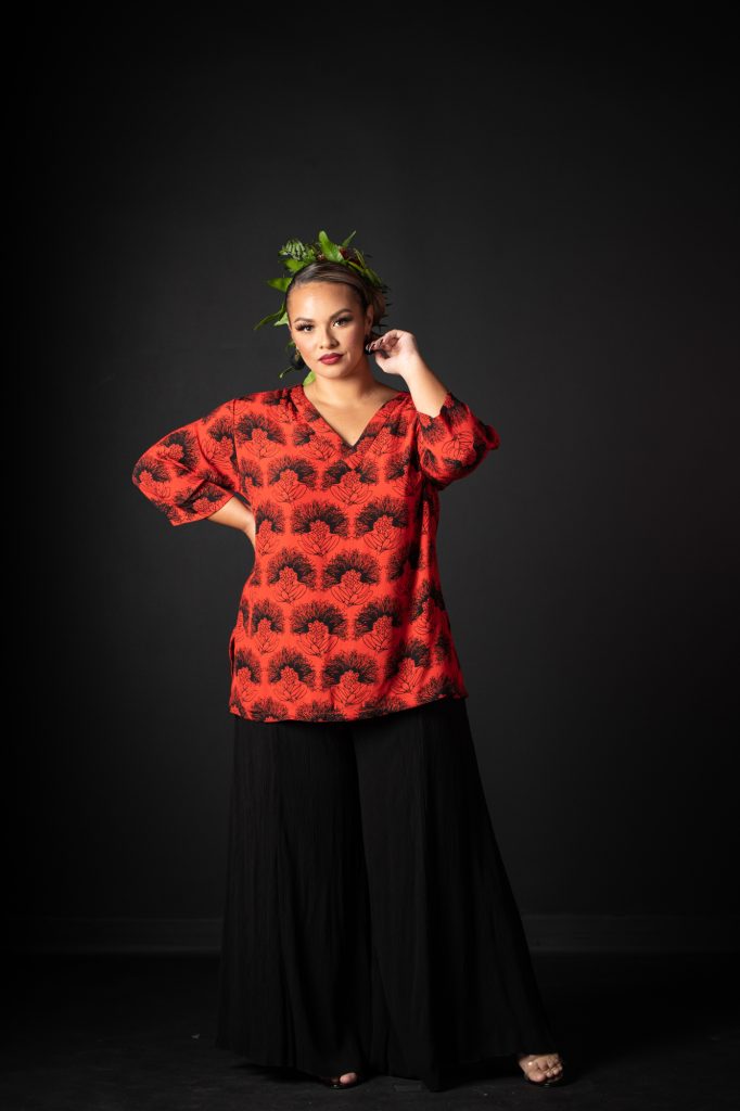 Model wearing Kahaku Top in Firey Red Black Kalihilehua Pattern