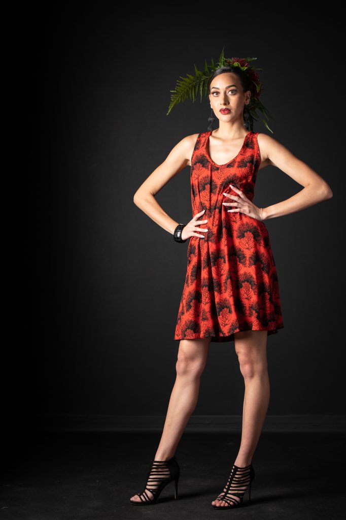 Model wearing Kaimanahila Short Dress in Firey Black-Red Kalihilehua Pattern - Front View